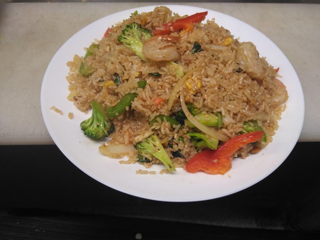 68. Kao Pad Gaprao · Fried rice cooked in a house chili and garlic sauce with Thai basil leaves, bell pepper, mushroom, onion and your choice of protein.