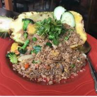 70. Pineapple Fried Rice · Fried rice served with fresh pineapple, carrot, cashew nuts, onion, green peas, eggs and you...