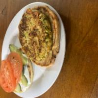Zucchini Veggie Burger · our own veggie burger topped with Cucumber, tomato, tzatziki sauce on grilled 4in pita.