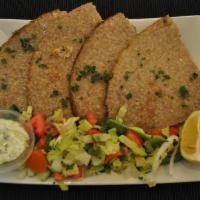Kibbeh Platter  · Stuffed with beef and lamb. Served with salad tzatziki sauce.