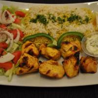 Chicken Tikka Over Rice · 2 skewers with rice, salad and tzatziki sauce.