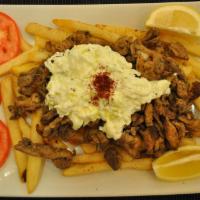 Chicken Shawarma Over Fries · Slices with tzatziki sauce.