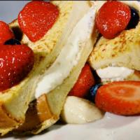 Very Berry Stuffed French Toast · Our french toast stuffed with sweet cream cheese. Then topped with strawberries, blueberries...