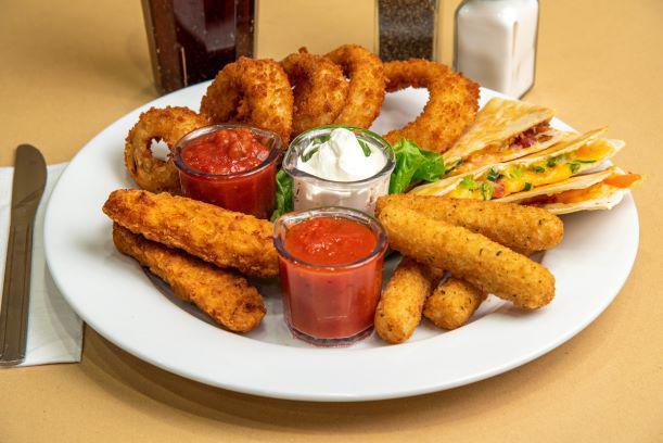 Appetizer Sampler · A mouthwaterting array of our most popular appetizers. Includes mozzarella sticks, onion rings, chicken tenders, and cheese quesadilla.