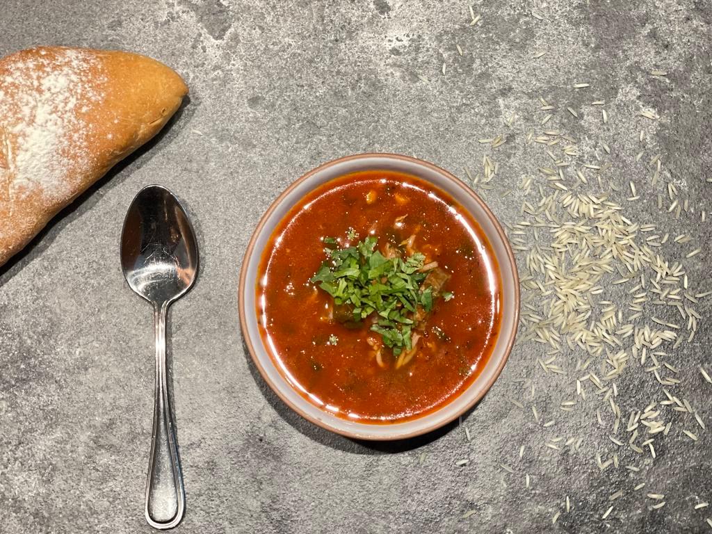 Soup Kharcho (Beef Soup) · Our winter soup made with spiced beef broth, tomato and rice, enriched with herbs and Georgian spices