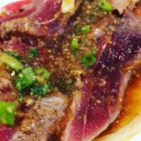 Tuna Tataki · Seared tuna on a bed of onions. Served with ponzu sauce.