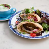Falafel Pita Sandwich · baked falafel with hummus, pickled red onions, tomato, parsley, pickles, tarator sauces in p...