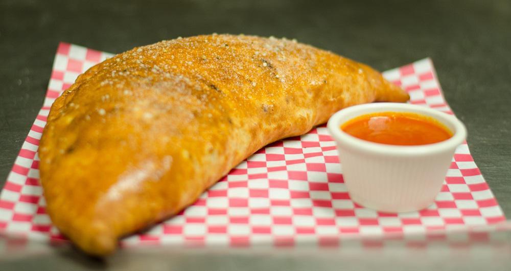 Greek Calzone · Cheese with spinach, feta cheese, artichoke hearts, sun-dried tomatoes and banana peppers.
