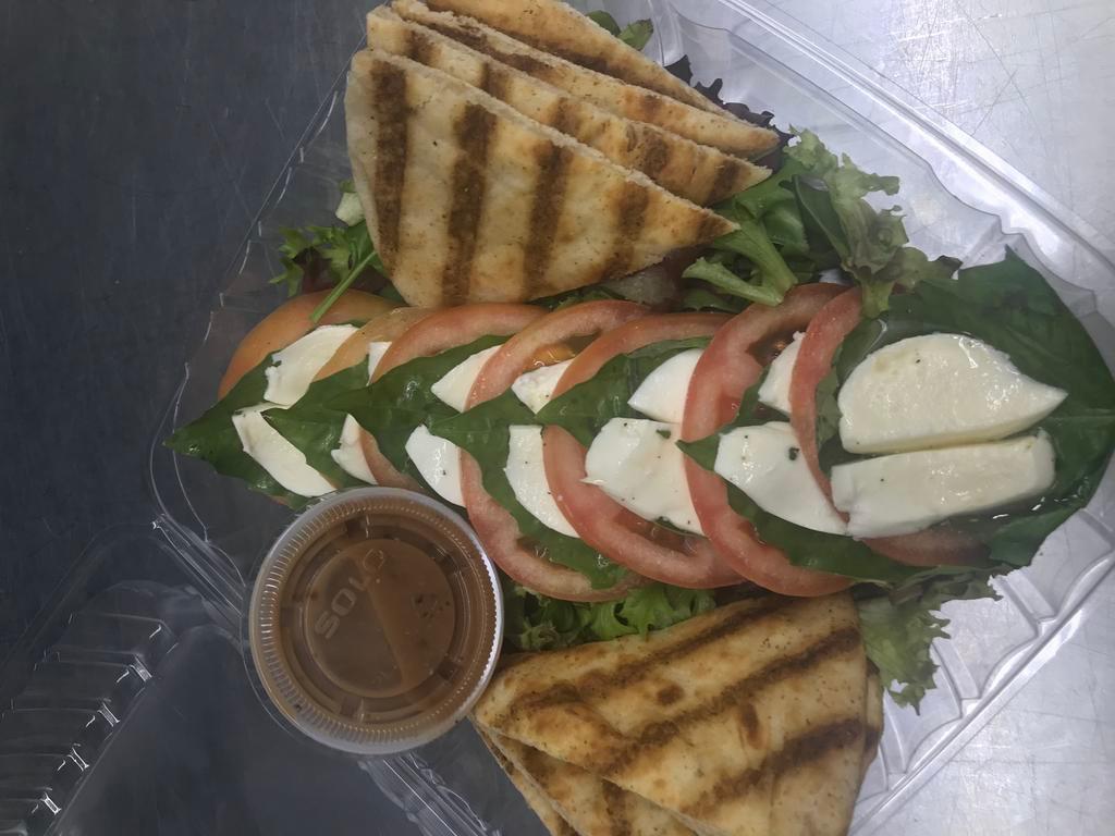 Caprese Salad · Fresh mozzarella and roasted red pepper on basil leaves drizzled with olive oil and balsamic vinaigrette. Served with warm pita triangles. 