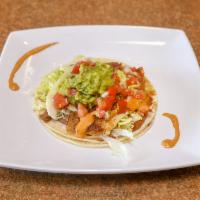 Fish Taco · Guacamole, refried bean spread, chipotle aioli, lettuce and salsa fresca.