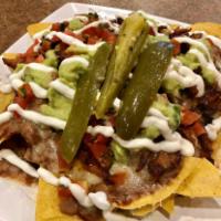 Super Nachos (NO MEAT) · Corn tortilla chips, loaded with Jack cheese, beans, enchilada sauce, salsa fresca, guacamol...