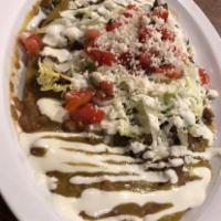 Carne Asada Huarache · Made from corn dough in the shape of a large sandal and crispy, lightly spread with refried ...
