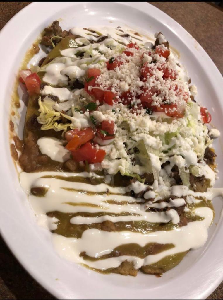 Carne Asada Huarache · Made from corn dough in the shape of a large sandal and crispy, lightly spread with refried beans, green sauce, queso fresco and sour cream.