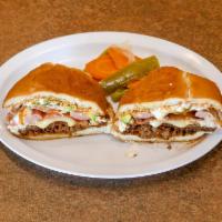 La Cubana Torta · Chorizo, milaneza, forest ham, carne asada. Served in a baked telera bread lightly spread wi...