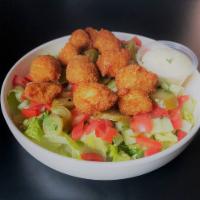 Schnitzel Salad · Boneless breast of chicken with cornflakes coating served on a bed of lettuce with your choi...
