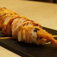 35-Lion · Snow crab, Avocado, Shrimp Tempura, topped with crab meat, massago, crunch with eel sauce an...