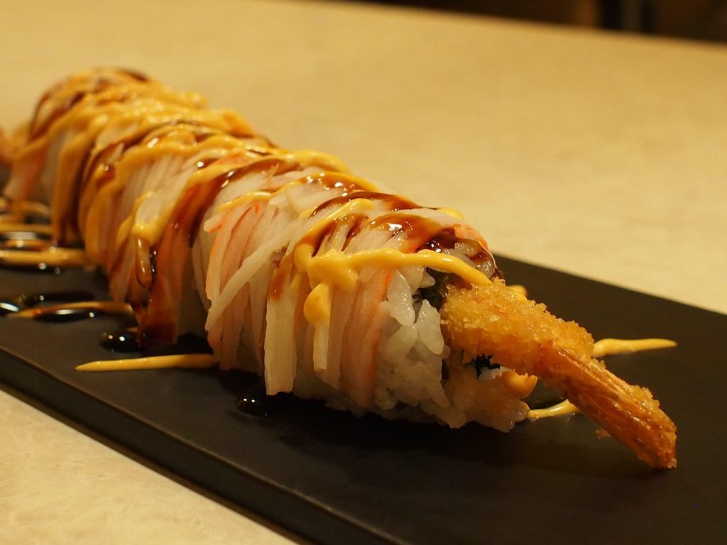 35-Lion · Snow crab, Avocado, Shrimp Tempura, topped with crab meat, massago, crunch with eel sauce and spicy mayo.
