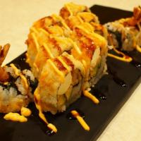 57-New Golden Dragon · 2 Tempura shrimp, cream cheese, peanut, yamagobo and avocado topped w/crunch, tobiko, srirac...