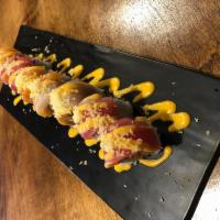 67-Beauty and Beast · Spicy tuna, avocado, mango, topped with tuna, salmon, yellowtail, coming with spicy mayo, cr...