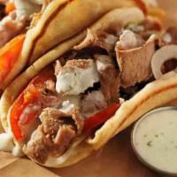 Gyros · Tender slices of gyros meat served on a pita with freshly sliced onions, tomato and tzatziki...