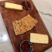 Artisan Cheese Board · Two selections of artisan cheese with house made seeded crackers + accompaniments