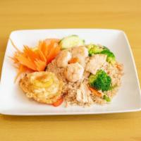 22. Curry Fried Rice · Stir-fried jasmine rice with bell pepper, onion, carrot, peas, basil leaves and green curry ...