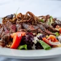 Grilled Steak Salad · Marinated skirt steak,mixed greens tossed with crispy tobacco onions, cherry tomatoes, Dubli...