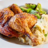 Half Roasted Chicken · Delightfully roasted half chicken served atop roasted garlic champ drizzled with rich chicke...
