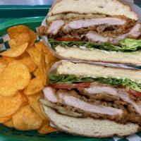 Fried Chicken Sandwich · Buttermilk Fried Chicken, Plum-Chili Sauce, Mayo, Lettuce, Tomato, and Pickles on a Seeded B...
