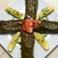 Stuffed Grape Leaves · Six pieces. Grape vines stuffed with rice, dill, mint and lemon.