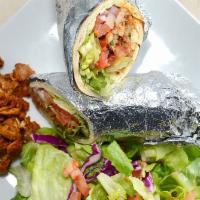 Chicken Shawarma Sandwich · Our chicken shawarma served with garlic spread, tomatoes, lettuce and onions.  Served in tor...
