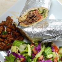 Beef Shawarma Sandwich · Our beef shawarma served with tahini sauce, hummus, tomatoes, lettuce and onions. Served in ...