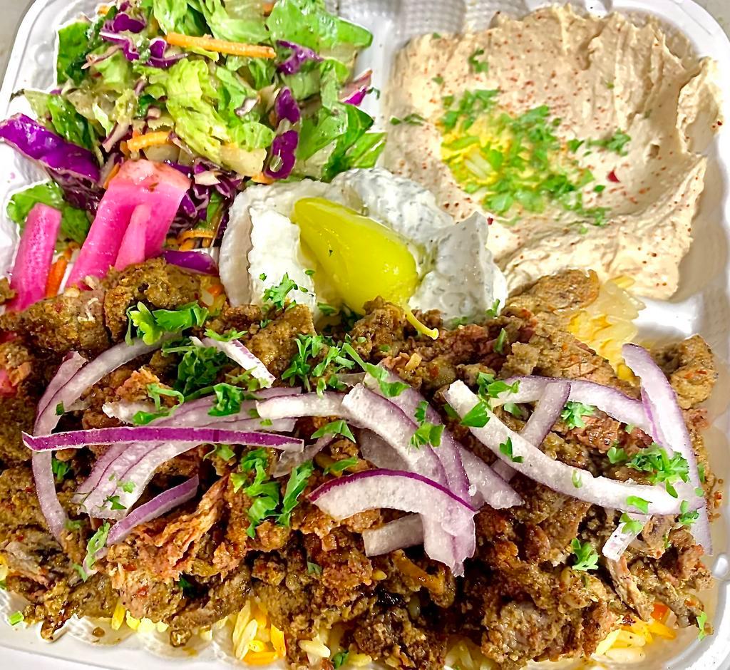 Beef Shawarma Entree · Our beef shawarma served with humus,rice,salad,taziki sauce, pickled turnip, peppercini and  Peta bread on the side.