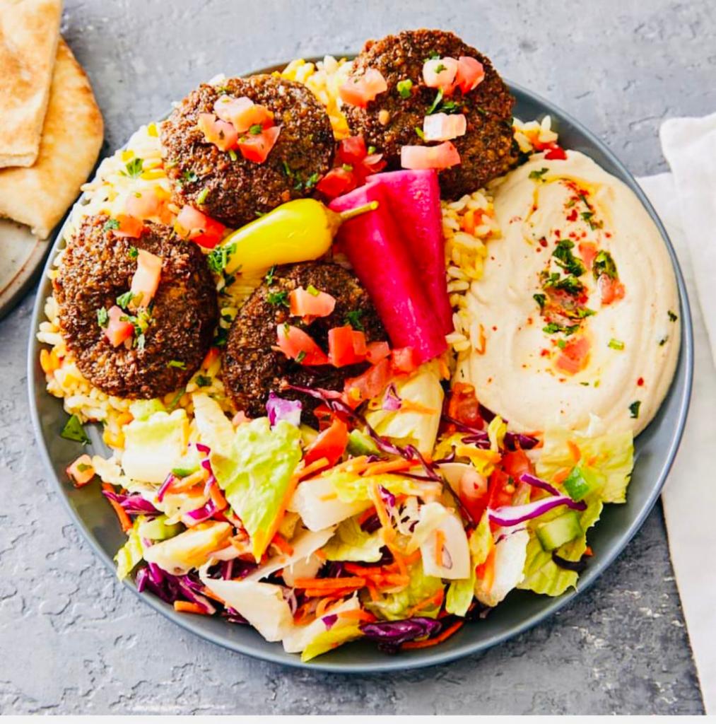 Falafel Plates · 6 pieces of falafel served with humus, rice, salad, tahini sauce, pickled turnip, peppercini and pita bread.