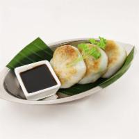 7. Chive Dumplings · Pan-fried soft rice flour patties stuffed with chives served with sweet soy sauce.