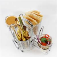 10. Chicken Satay Appetizer · Grilled curry marinated chicken strips served with pan fried roti, side of cucumber salad an...