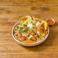 Nachos al Carbon · A large portion of homemade chips layered with refried beans, cheese sauce, lettuce, guacamo...