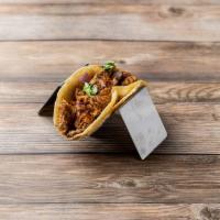 Spicy Pork Taco · Seared shredded pork, cilantro, onion, spicy Thai sauce (sweet and spicy chili sauce) and se...