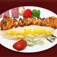 28. Joujeh Kabob · Marinated tender cornish ham, grilled, served with premium basmati rice topped with saffron.