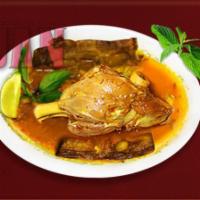 25A. Lamb Shank · A whole lamb shank in special tomato sauce, eggplant and sour grape, served with dill rice.
