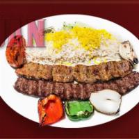 34. Lamb Soltani · Skewer of tender lamb or beef chenjch and a skewer of premium quality house ground beef kabob.