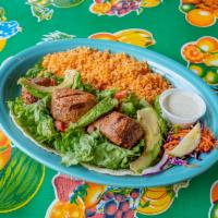 Open-Faced Tuna Tacos · Ahi grade tuna marinated ＆ grilled to perfection. Served open faced on our salad mix with pi...