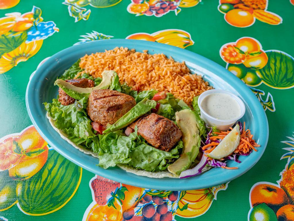 Open-Faced Tuna Tacos · Ahi grade tuna marinated ＆ grilled to perfection. Served open faced on our salad mix with pico de gallo, roasted poblanos, avocado ＆ jalapeño-lime sauce on corn tortillas, served medium rare with rice on the side.
