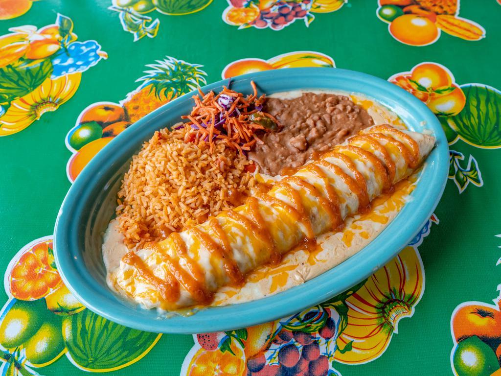 Fajita Beef Pipeline Enchilada · Grilled fajita steak and mixed cheese rolled in fresh corn tortillas topped with salsa roja sauce, served with rice ＆ refried beans.