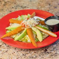Southwest Salad · Big green salad topped with deep- fried chicken tenders, sliced tomatoes avocados, Monterey ...