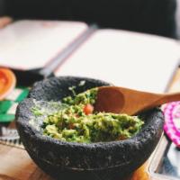 Guacamole al Molcajete · Avocado, tomato, onion, cilantro, salt, lime. Comes with chips