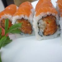 Pink Lady Roll · Spicy crunchy salmon inside with fresh salmon on top. Made with brown rice upon request.