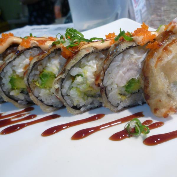 New Volcano Roll · White tuna, crab and avocado inside, fried with eel sauce, spicy mayo, sriacha sauce and masago.