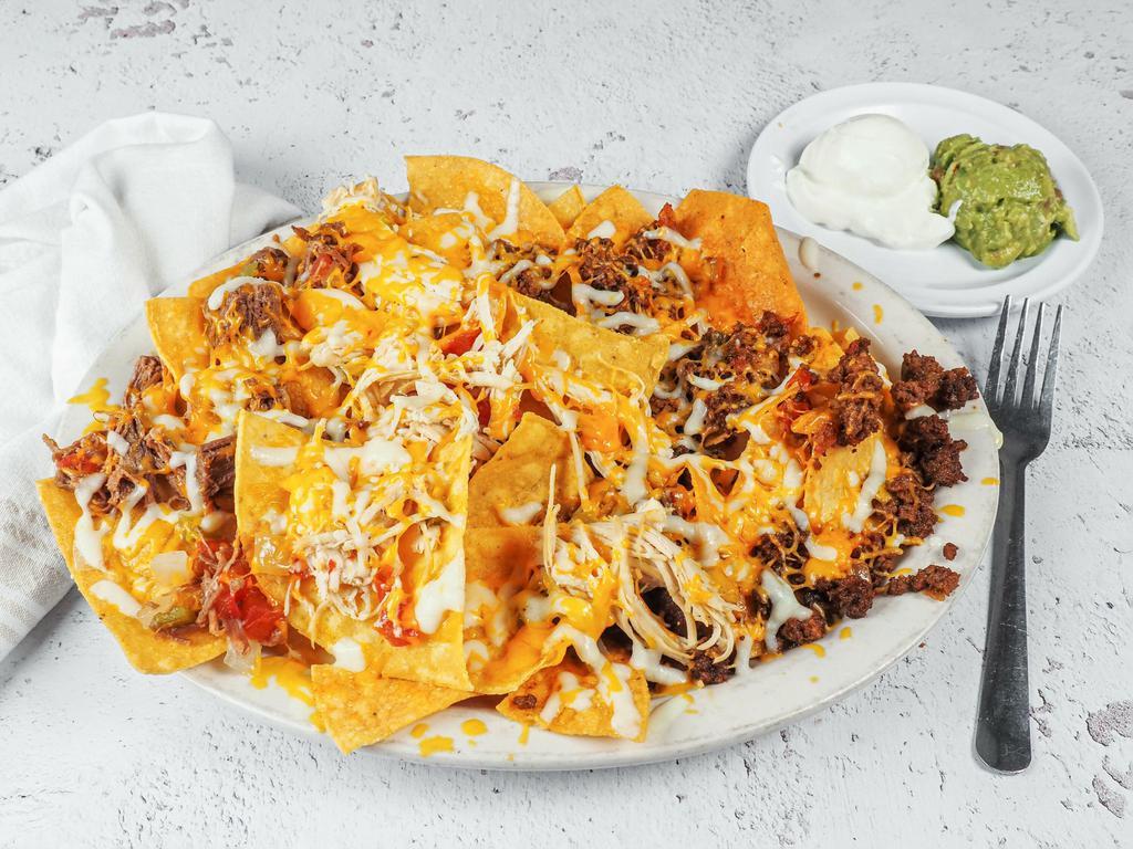 Zapata Nachos · Tortilla chips with beef or chicken fajita, beans, cheese, jalapenos, guacamole and sour cream with 2 flautas on top (beef or chicken).