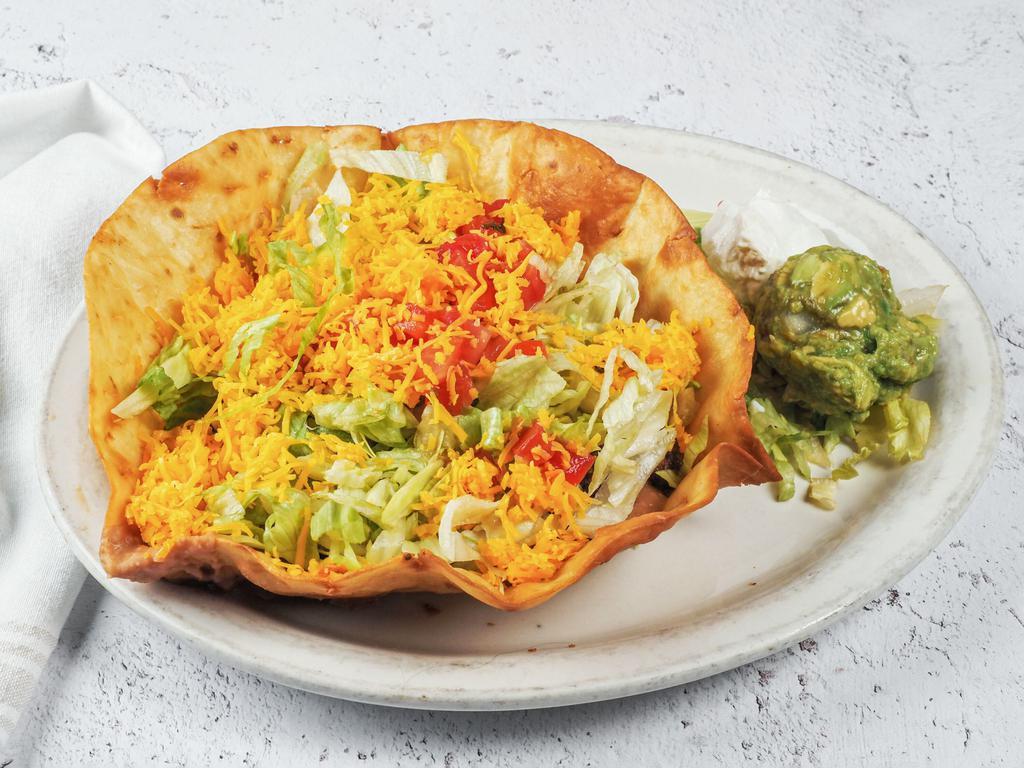 Taco Salad · 1 flour tortilla shell with beef or chicken covered with beans, lettuce, tomatoes, cheese, guacamole and sour cream.